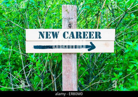 NEW CAREER written on Directional wooden sign with arrow pointing to the right against green leaves background. Concept image with available copy space Stock Photo