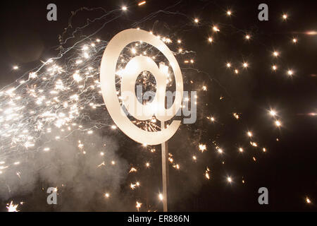 Illuminated at symbol with fireworks at night Stock Photo