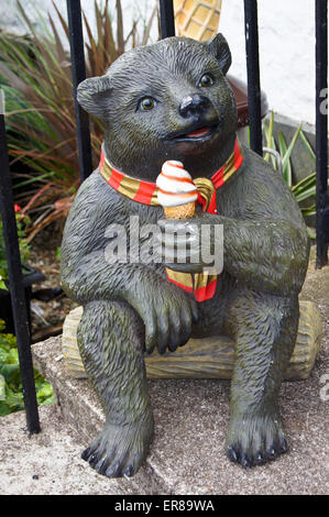 Statue of a smiling bear eating an ice cream cone advertising an ice cream parlour, Inveraray, Argyll and Bute, Scotland Stock Photo