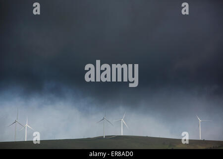 Stormy clouds over wind turbines on agricultural field Stock Photo