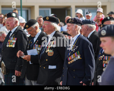 Normandy War Veterans on parade at D-Day Anniversary ceremony in Arromanche, site of the British allied forces landing beaches,  Stock Photo