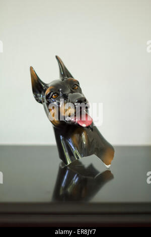 Dog figurine on table against white background Stock Photo