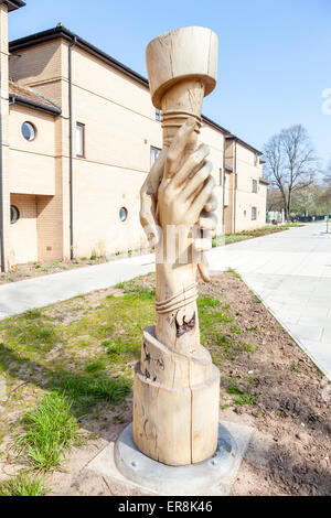Friendship: A Handshake. One of twelve sculptures carved from trees felled along the tram line through the Meadows, Nottingham Stock Photo