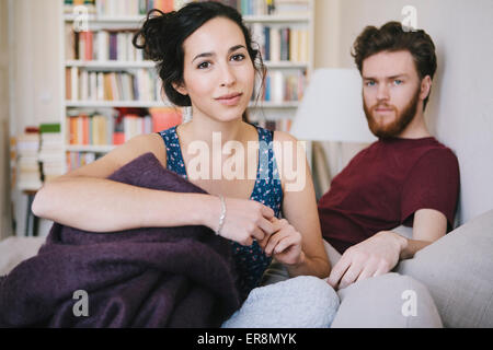 Portrait of young woman with man relaxing in bed Stock Photo