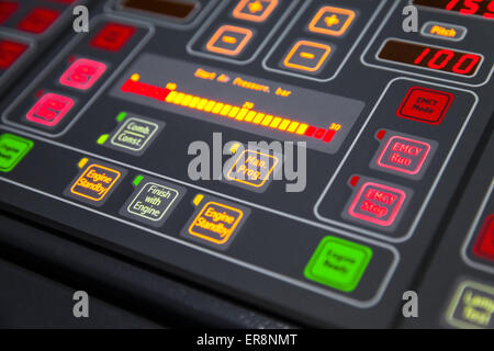Fragment of illuminated ship control panel on the captain bridge in the dark. Selective focus, shallow DOF Stock Photo