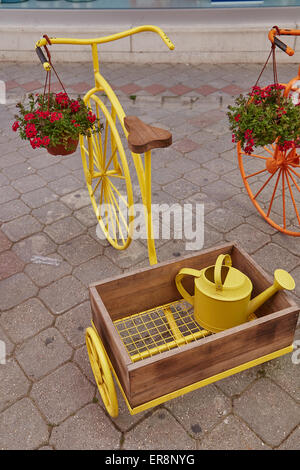 Ornamental penny farthing tricycles planters, with trugs on display in Fethiye's old town, Turkey. Stock Photo