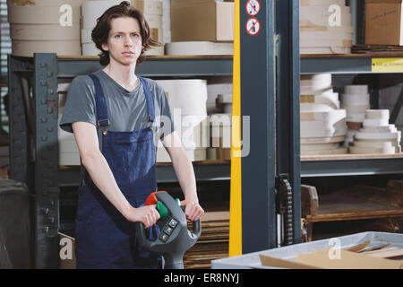 Portrait of young male worker working in warehouse Stock Photo