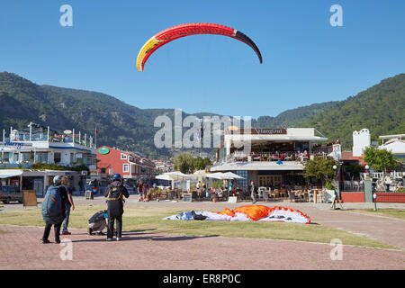 Paragliding in Oludeniz, Near Fethiye, Turkey. Coming in to land on the beachfront. Stock Photo