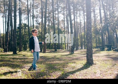 Full length of boy walking in forest Stock Photo