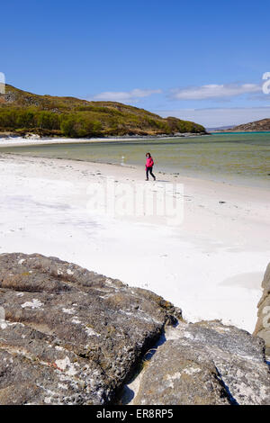 Woman walking on The 'Silver Sands of Morar' in the Scottish Highlands on the North West Coast close to Mallaig Stock Photo