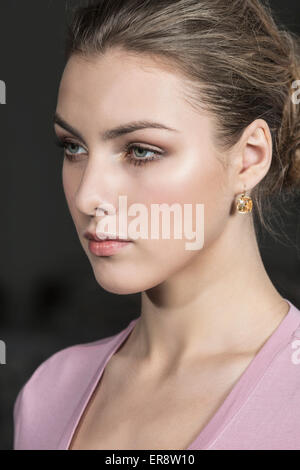 Close-up of thoughtful young woman against gray background Stock Photo