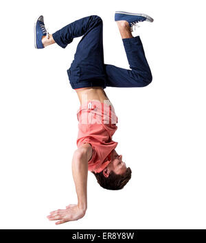 Break dancer doing one handed handstand against a white background Stock Photo