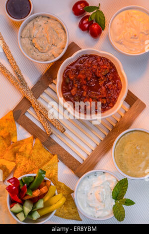 A selection of party dips with bread sticks and other crudites. Stock Photo