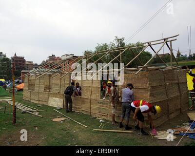 Kathmandu, Nepal. 29th May, 2015. Volunteers work to build temporary classrooms outside a damaged school in Kathmandu, capital of Nepal, on May 29, 2015. Schools in quake-affected districts are making further preparations to resume classes scheduled on May 31. Credit:  Sunil Sharma/Xinhua/Alamy Live News Stock Photo