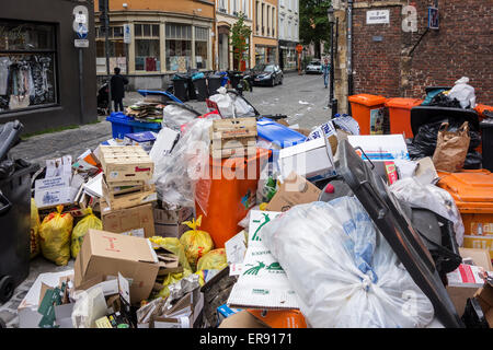 Pile of rubbish bags and garbage containers with household refuse blocking street in city due to strike by waste processing firm Stock Photo