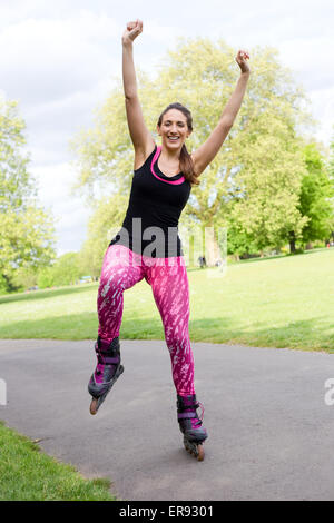 young woman balancing on her rollerblades. Stock Photo
