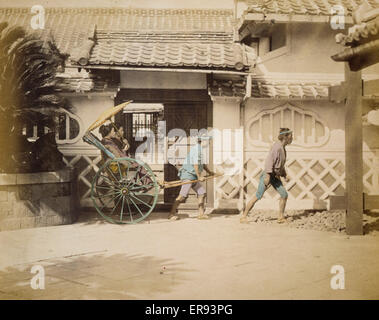 Two women riding in a rickshaw Stock Photo