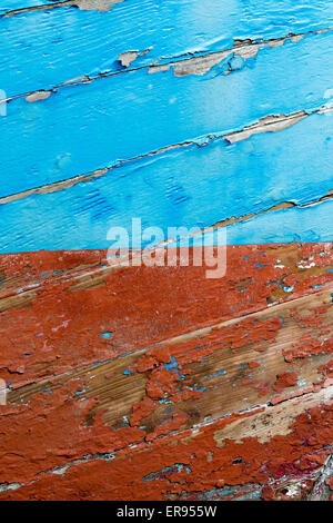 Old weathered orange and blue wooden hull Stock Photo