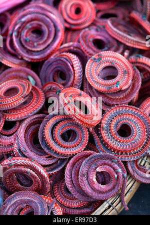 Dried River Snakes on sale at food market in Cambodia Stock Photo