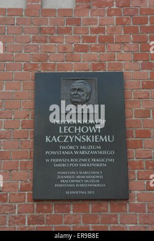 Portrait shot brick wall with memorial plaque to tragic death of President Lech Kazcynski in 2010, Warsaw Uprising Museum Stock Photo