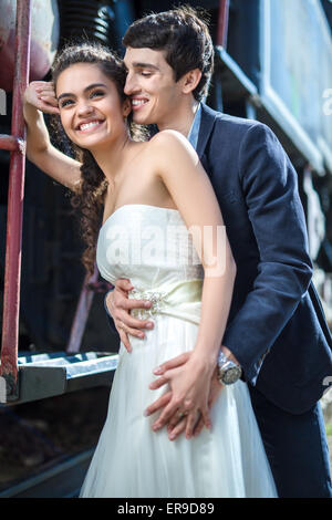 Portrait of happy wedding couple near the old steam locomotive Stock Photo