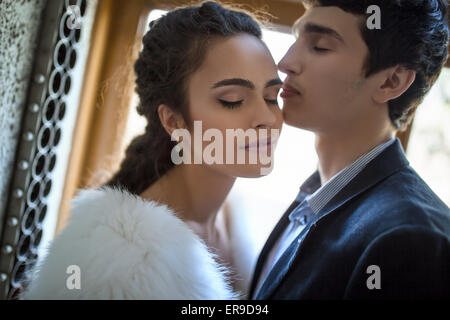 Portrait of happy wedding couple in classic interior Stock Photo