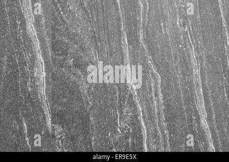 Dark gray granite smooth stone wall texture background Stock Photo