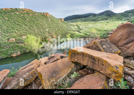 sandstone blocks on the old quarry on a shore of Horsetooth Reservoir with a view of mountain valley in Lory State Park, Fort Co Stock Photo