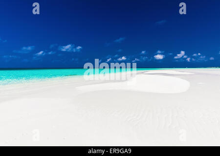 Small empty sandbar in the middle of tropical lagoon in atoll of Maldives Stock Photo