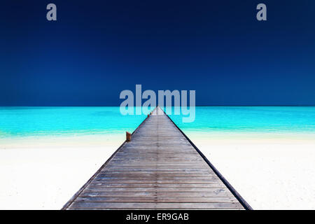 Wooden long jetty over lagoon with amazing clean azure water Stock Photo