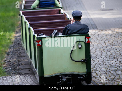 Dresden, Germany. 21st May, 2015. A train with a arrives at the station in the Grosser Garten in Dresden, Germany, 21 May 2015. The park railway celebrates its 65th birthday on 1 June. Photo: Arno Burgi/dpa/Alamy Live News Stock Photo