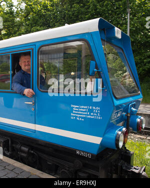 Dresden, Germany. 21st May, 2015. The EA02 engine of the Dresden Park Railway (Dresdner Parkeisenbahn) with train driver Hans-Joachim Gutte, arrives at the station in the Grosser Garten in Dresden, Germany, 21 May 2015. The park railway celebrates its 65th birthday on 1 June. Photo: Arno Burgi/dpa/Alamy Live News Stock Photo