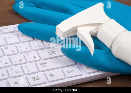 Airbrush with rubber gloves on keyboard Stock Photo