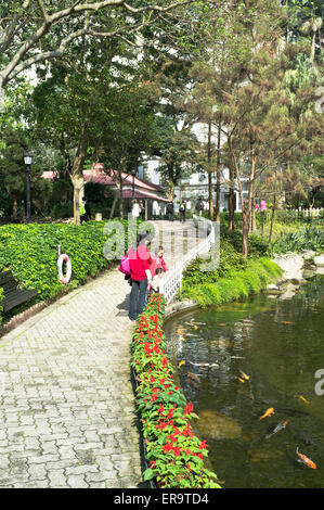 dh Hong Kong Park CENTRAL HONG KONG Chinese mother and children by fish pond in Hong Kong park people ponds china family outdoors garden Stock Photo