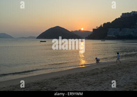 dh Repulse Bay Beach REPULSE BAY HONG KONG Sunset over Repulse Bay childern playing on beach Stock Photo