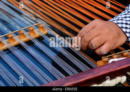 Stefan Fieraru tuning a Cimbalon, a concert hammered dulcimer Stock Photo