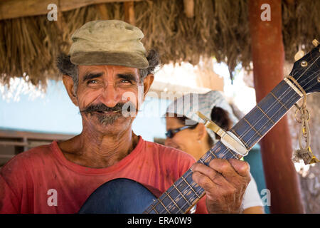Portrait of elderly man with guitar singing in Trinidad Cuba Stock Photo