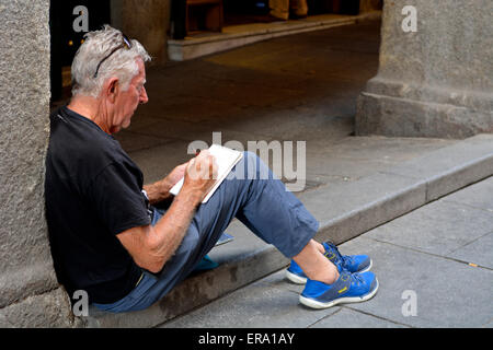 Tourist sketching in Plaza Mayor, Madrid, Spain Stock Photo