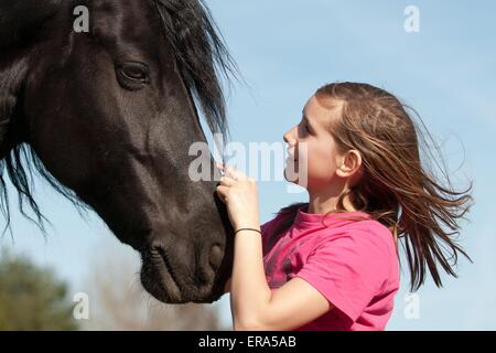 girl and Friesian horse Stock Photo