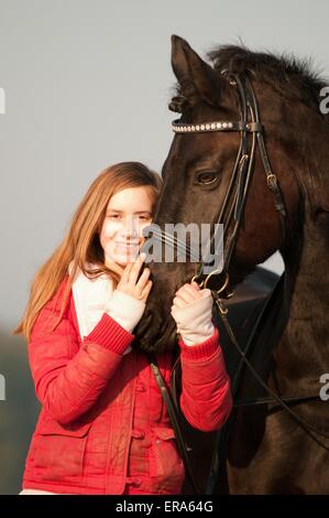 girl and Friesian horse Stock Photo