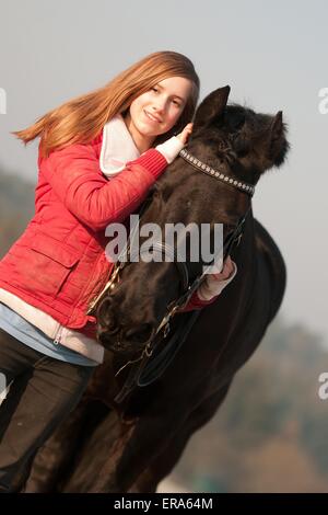 girl and Friesian horse Stock Photo