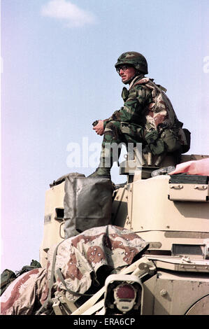 25th March 1991 A U.S. Army soldier keeps watch on top of a Bradley Cavalry Fighting Vehicle, on the border in northern Kuwait.