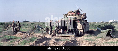 25th March 1991 U.S. Army soldiers bivouacked next to their Bradley Cavalry Fighting Vehicle, on the border in northern Kuwait.