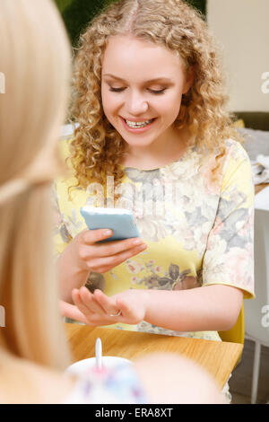 Smiling woman taking picture of her wedding ring Stock Photo