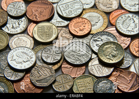 British coinage on a table and in the hand Stock Photo