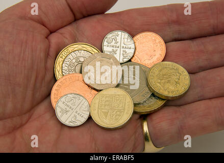 British coinage on a table and in the hand Stock Photo