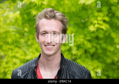 portrait of a young blond man in a black leather jacket Stock Photo