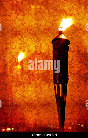 Vintage textured picture of glowing torch head against with reflection of light (texture added, grunge effect image, toned red) Stock Photo