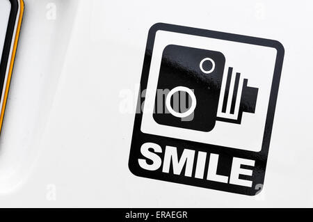 Cheeky sticker on the rear of a car with a speed camera and 'smile'. Stock Photo