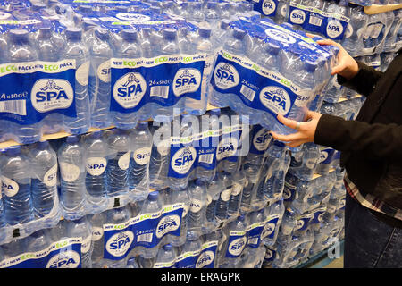 THE NETHERLANDS - MARCH 2015: Stack of with 24-packs of shrink wrapped Spa Reine water bottles in a wholesale. Stock Photo